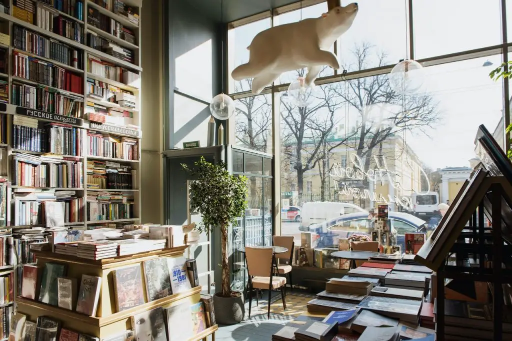 inside a bookstore with a white polar bear suspended from ceiling.