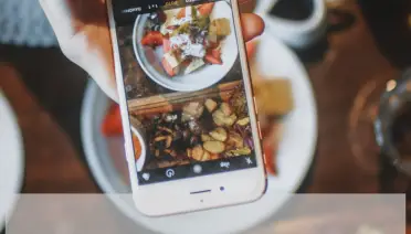 food blogger taking a photo of food using her phone